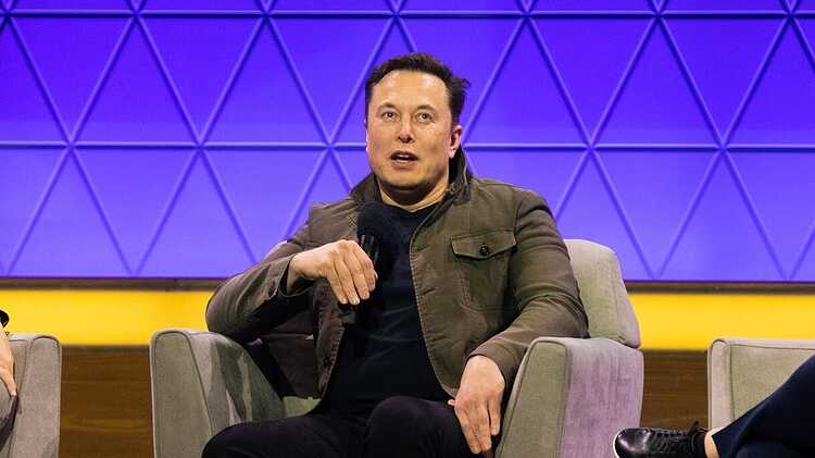 Elon Musk on stage an an interview